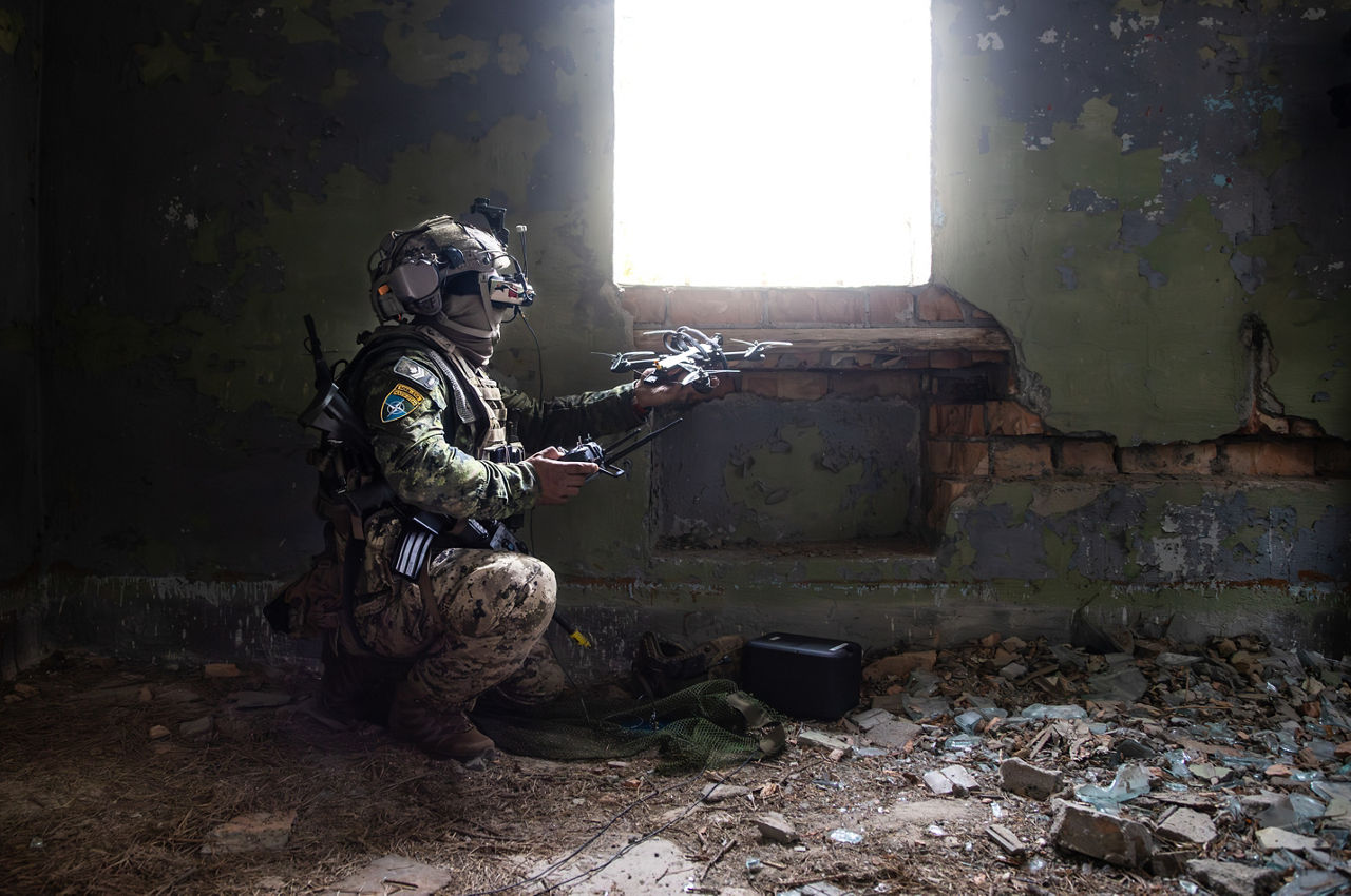 A Canadian drone pilot launching an FPV drone from an abandoned building. NATO’s Multinational Brigade in Latvia regularly runs training exercises where troops integrate all kinds of drones, making sure Allied forces keep up with innovations in modern warfare.
