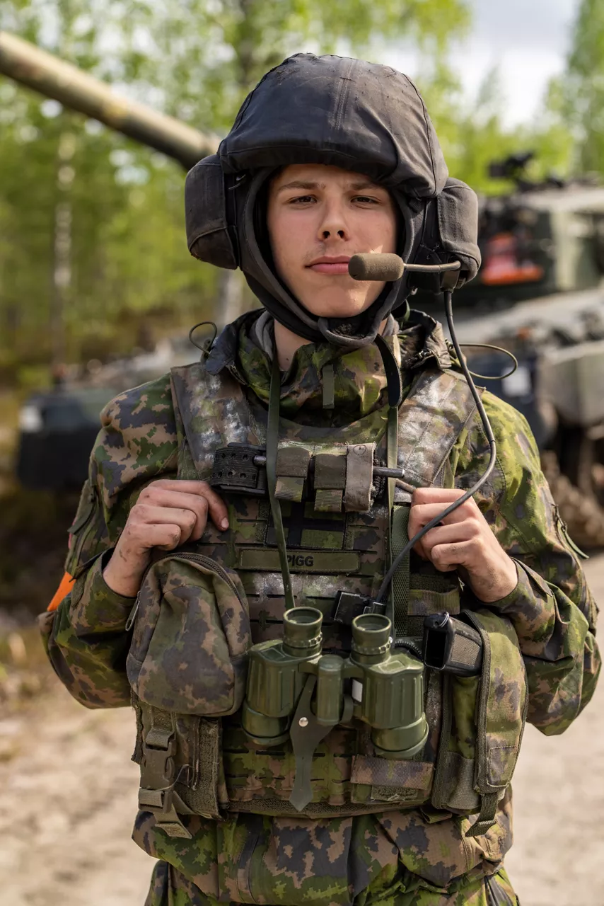 A Finnish conscript looks directly at the camera in front of a Finnish Leopard 2 tank.

Exercise Northern Star 26 brings together more than 5,000 troops from seven NATO Allies – Finland, France, Hungary, Italy, Poland, the United Kingdom and the United States for joint training in the forests of Kainuu, Finland. Soldiers train side by side in dense terrain, combining air and ground operations as Chinook helicopters insert troops into landing zones, while armoured units manoeuvre and infantry advance through the forest to engage in simulated combat. For many Finnish conscripts, this marks the final and most demanding phase of their military service, testing skills developed throughout their training. Working together in these conditions helps Allied forces strengthen coordination and improve how they operate together in harsh terrain. The exercise runs from 18 to 30 May 2026.