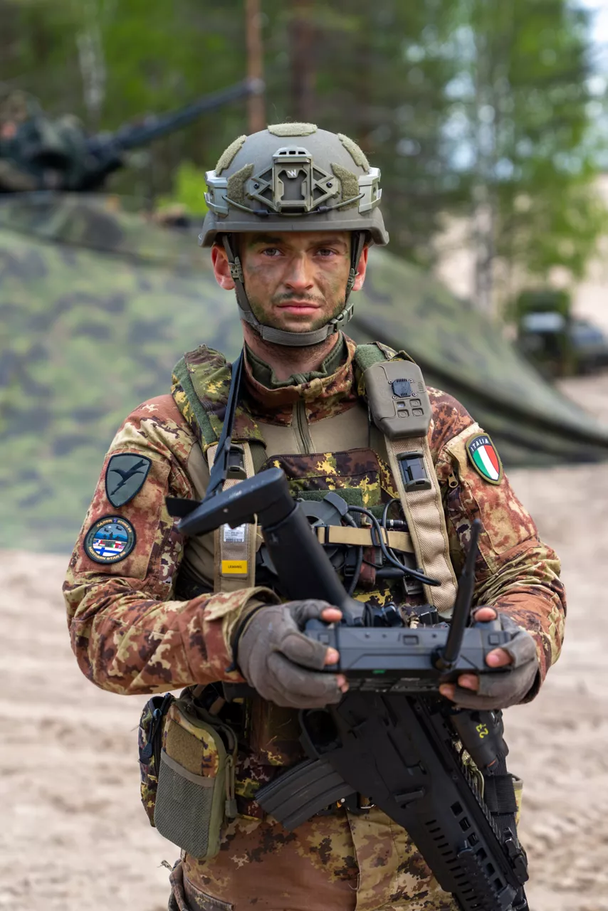 An Italian soldier looks directly at the camera while holding a drone controller.

Exercise Northern Star 26 brings together more than 5,000 troops from seven NATO Allies – Finland, France, Hungary, Italy, Poland, the United Kingdom and the United States for joint training in the forests of Kainuu, Finland. Soldiers train side by side in dense terrain, combining air and ground operations as Chinook helicopters insert troops into landing zones, while armoured units manoeuvre and infantry advance through the forest to engage in simulated combat. For many Finnish conscripts, this marks the final and most demanding phase of their military service, testing skills developed throughout their training. Working together in these conditions helps Allied forces strengthen coordination and improve how they operate together in harsh terrain. The exercise runs from 18 to 30 May 2026.