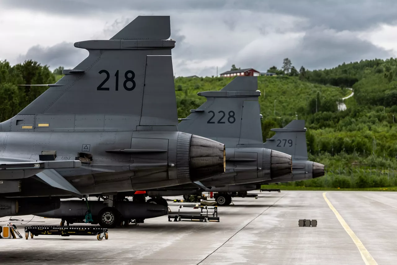 Swedish Air Force JAS 39 Gripens sit on the tarmac at Bardufoss Air Station in Norway during exercise Ramstein Flag 26. This year’s iteration of NATO's annual large-scale exercise involved 18 nations flying more than 200 aircraft from 20 different locations across Europe, including several air bases in the High North. The Swedish Air Force sent a detachment of Gripens to Air Station Bardufoss, where Norway has brought a Cold War-era bunker-hangar complex back into use after roughly four decades of dormancy.