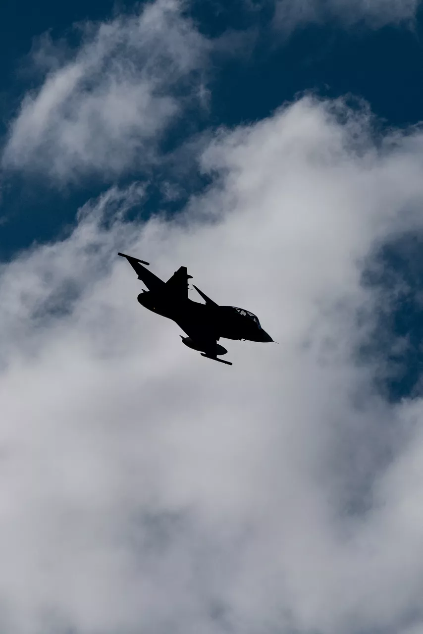 A Swedish Air Force JAS 39 Gripen cuts across the clouds before landing at Bardufoss Air Station in Norway during exercise Ramstein Flag 26. This year’s iteration of NATO's annual large-scale exercise involved 18 nations flying more than 200 aircraft from 20 different locations across Europe, including several air bases in the High North. The Swedish Air Force sent a detachment of Gripens to Air Station Bardufoss, where Norway has brought a Cold War-era bunker-hangar complex back into use after roughly four decades of dormancy.