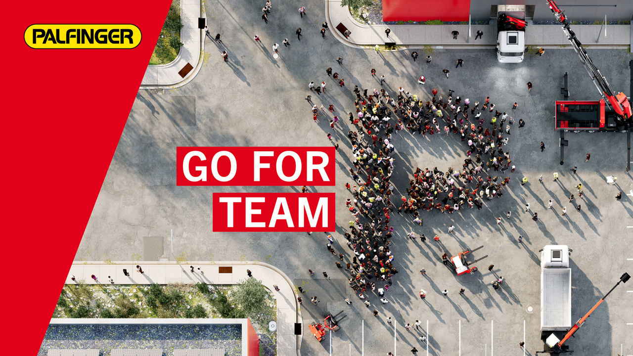 Aerial view of a large group of people forming the letter “P” in a courtyard, with PALFINGER branding and the slogan “GO FOR TEAM P” displayed prominently.
