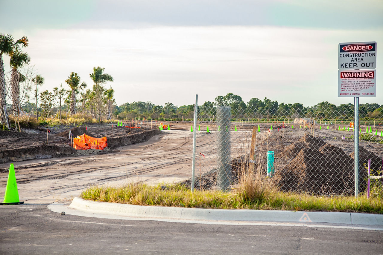 A new road is under construction with several pieces of heavy equipment