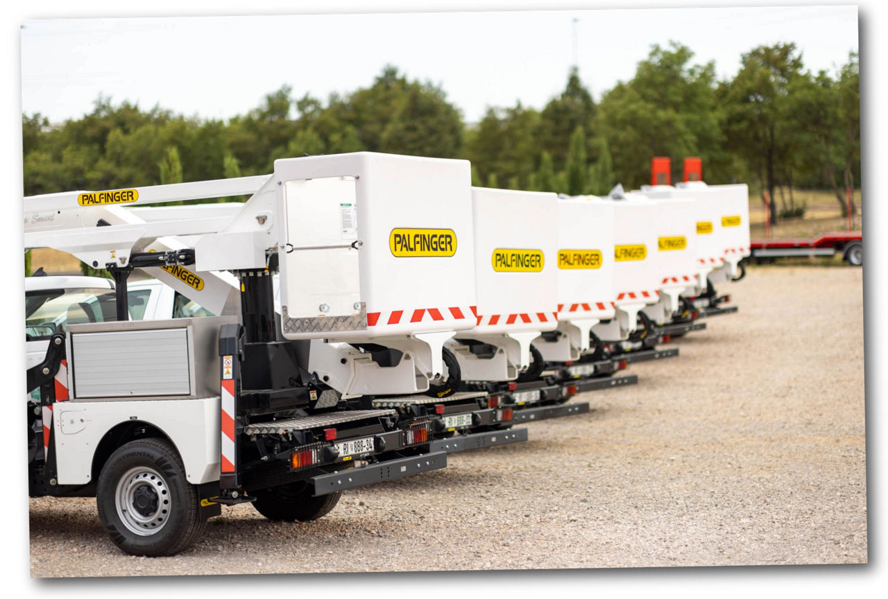 Row of white PALFINGER aerial work platforms