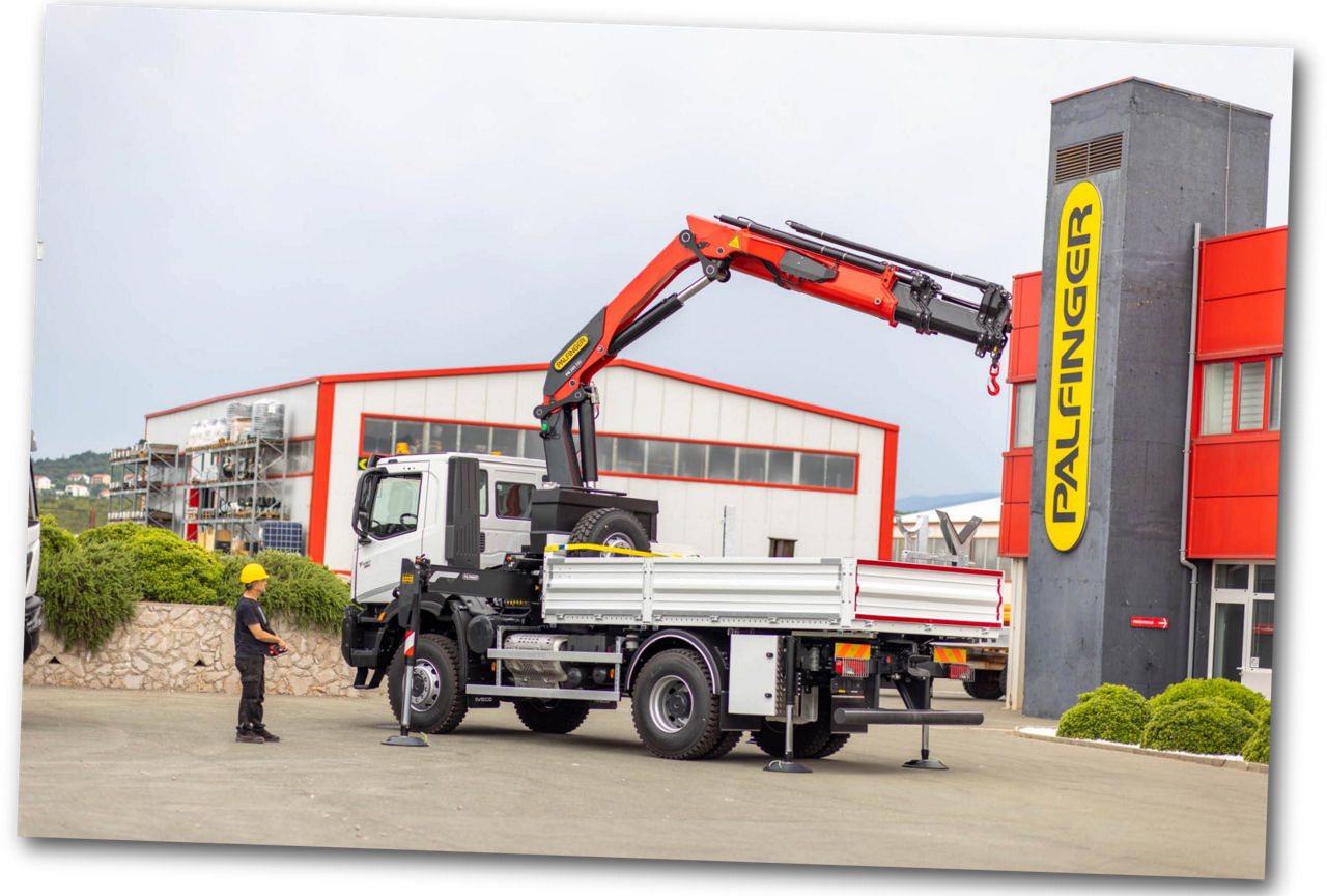 PALFINGER loader crane with an operator holding a remote control