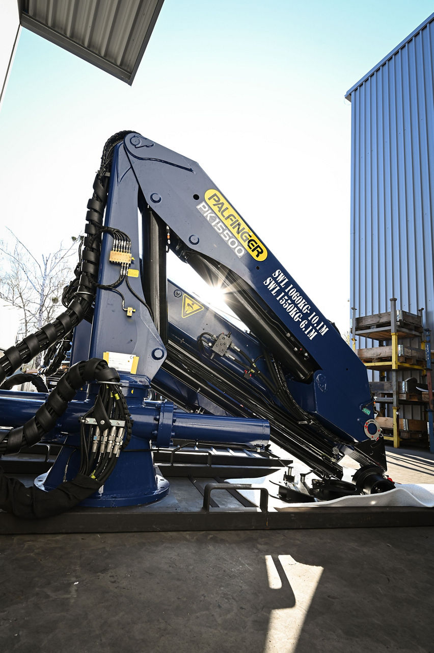 Showing a PALFINGER crane PK 15500 in front of the production site in Maribor, Slovenia
