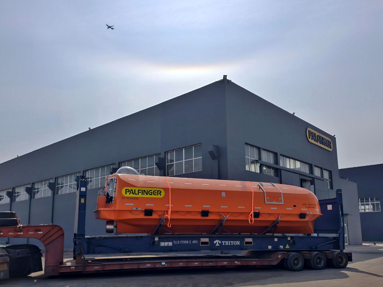 A lifeboat ready for transport in front of the production site