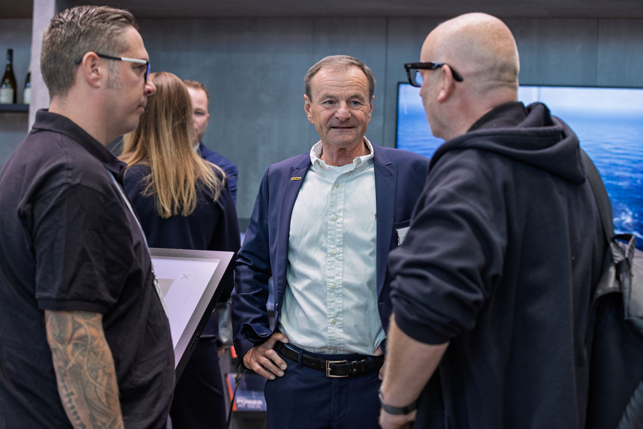 Rupert Reischl, PALFINGER, talking to visitors at the booth
