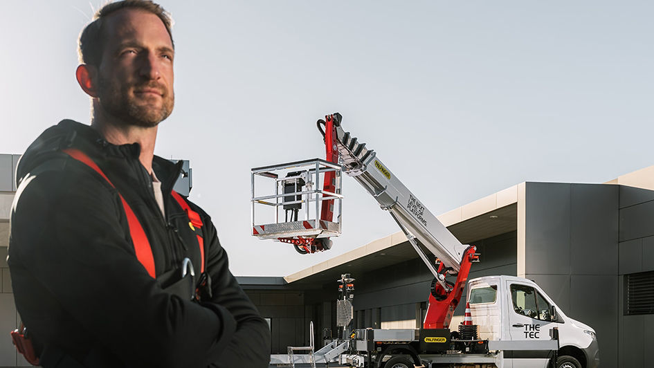 PALFINGER flags that show logo and claim