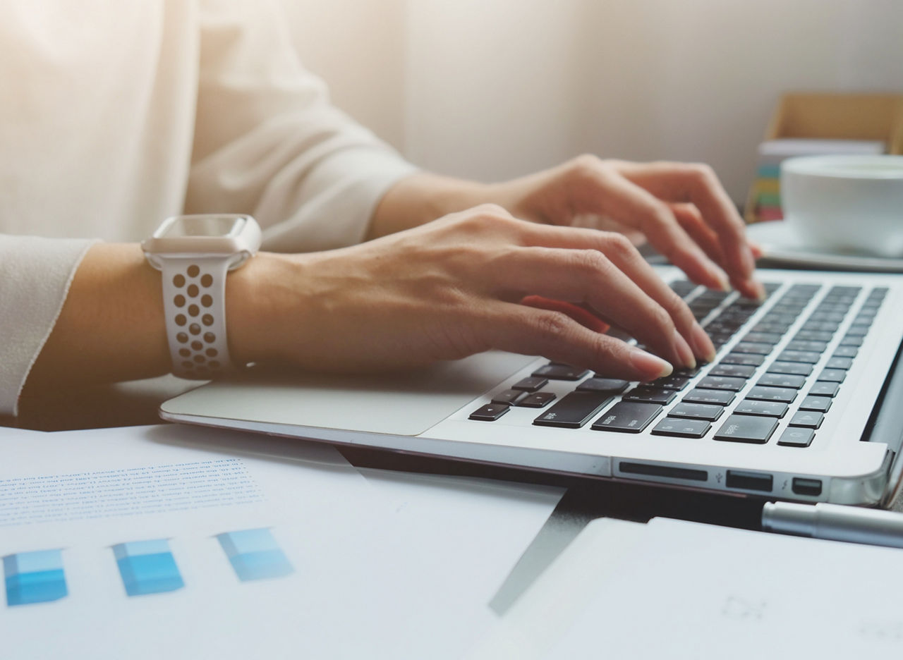 Asian woman is typing on keyboard of laptop or computer notebook for check electronic mail, preparation of presentation in meeting, get information for shopping online or operation of internet banking