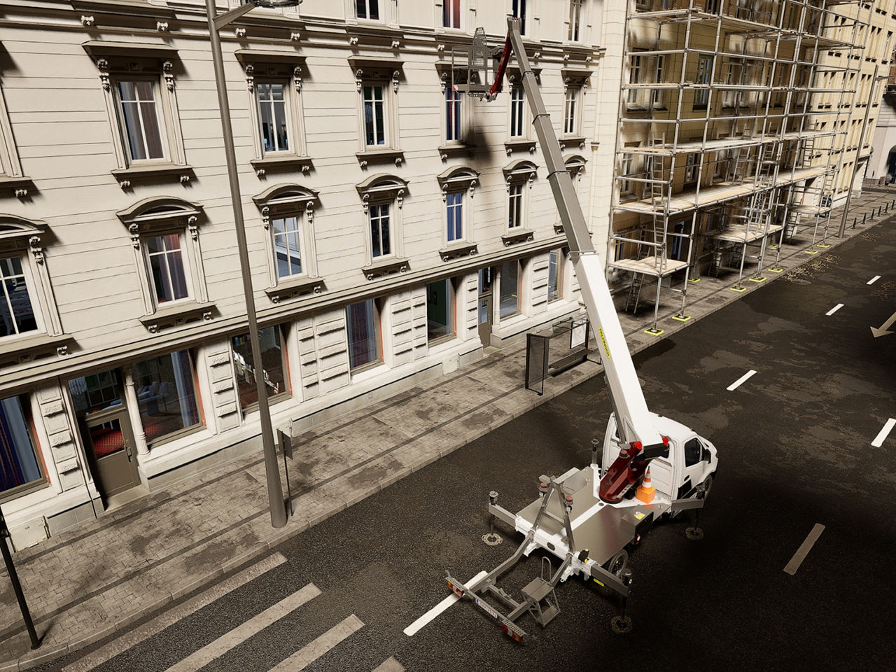 High-angle view from above showing the truck-mounted lift aligned along the street with stabilizers extended.