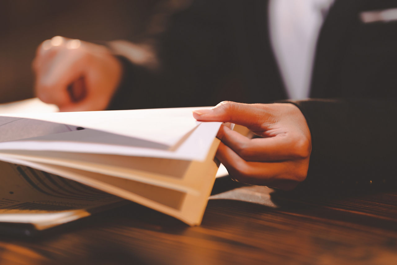 businesswoman person's hand stamping with approved stamp on certificate document public paper at desk, people work in notary law or business finance agreements, lawyer paperwork in confidential