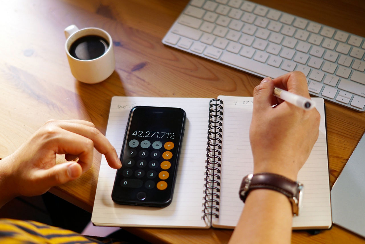 closeup-shot-entrepreneur-working-from-home-doing-calculations.jpg