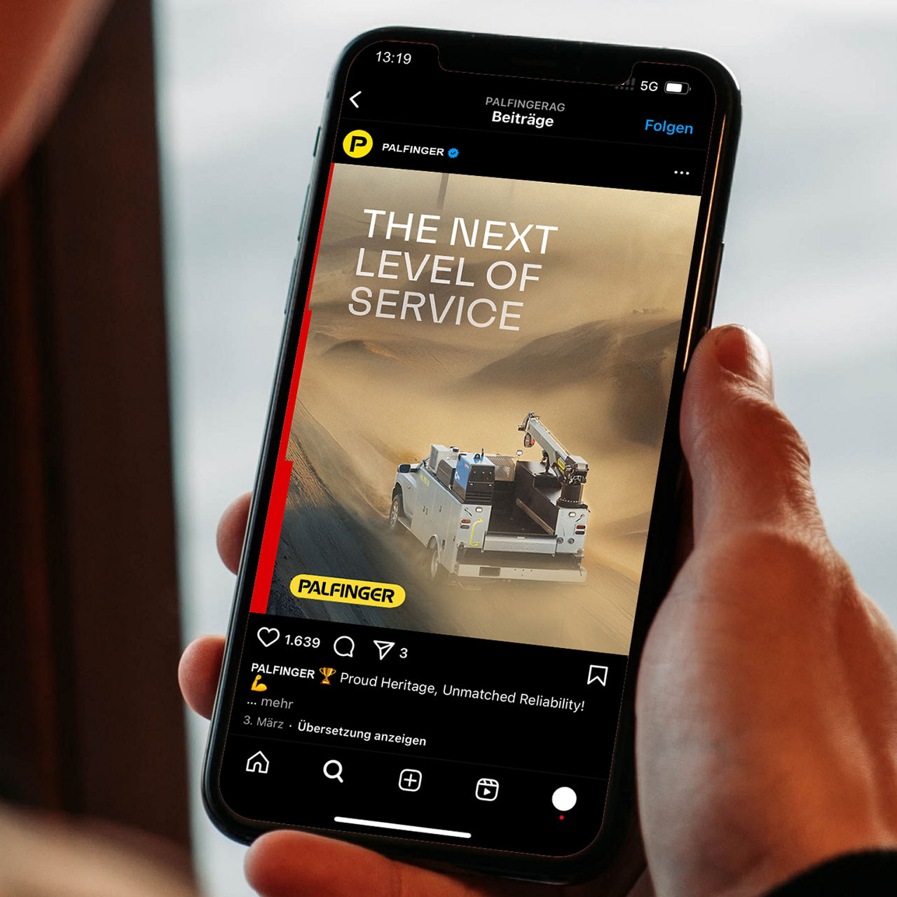 Freestanding PALFINGER roll-up banner with a crane image and bold headline displayed in a modern indoor environment.