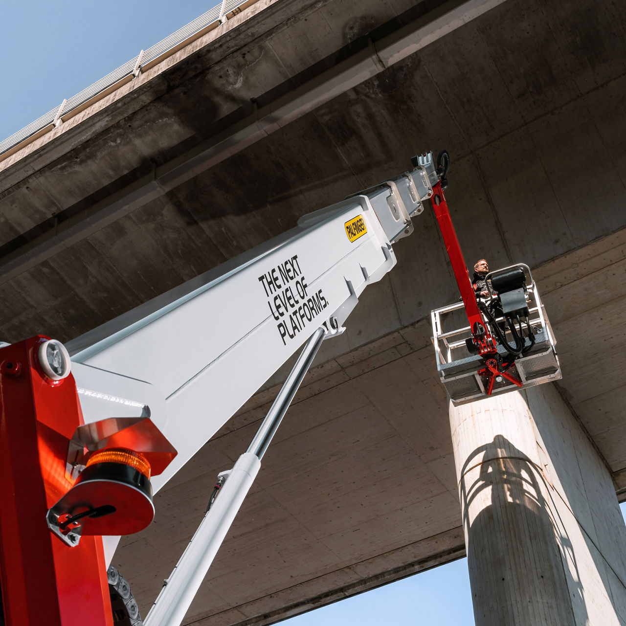 PALFINGER magazine layout featuring a close-up of a crane hook alongside a headline and editorial text.