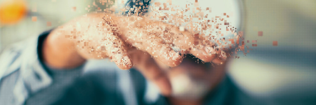 Close-up of an outstretched hand with digital particles dissolving and floating upward, symbolizing transformation, innovation, and the transition from physical to digital systems