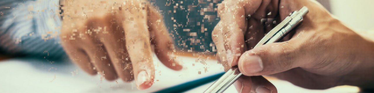 A picture of two hands writing a legacy as the particles of the letters embark an amazing glory of the innovation