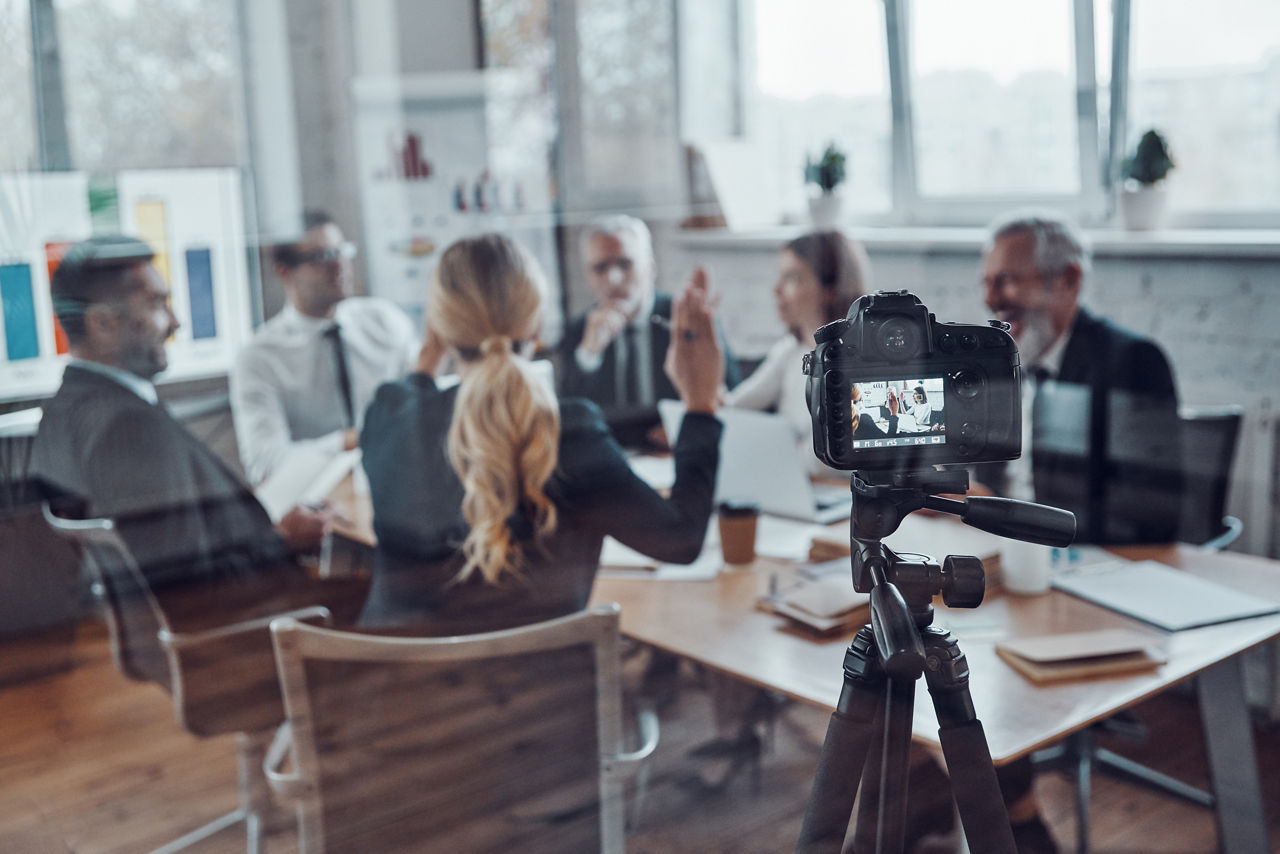 Successful business team discussing strategy while filming staff meeting in the board room                   , Successful business team discussing strategy while filming staff meeting in the board room                   