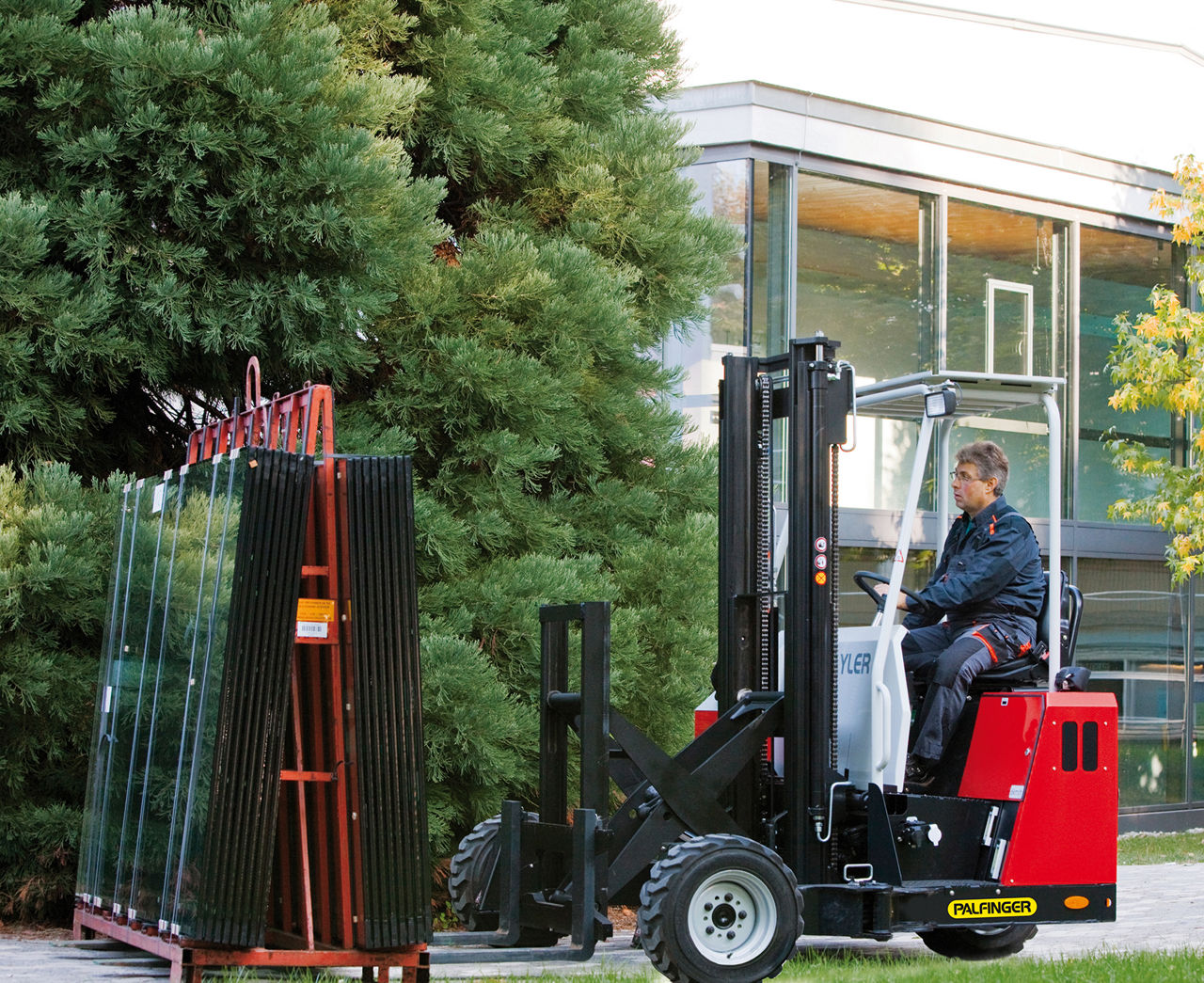 Truck mounted fork lift transporting glas