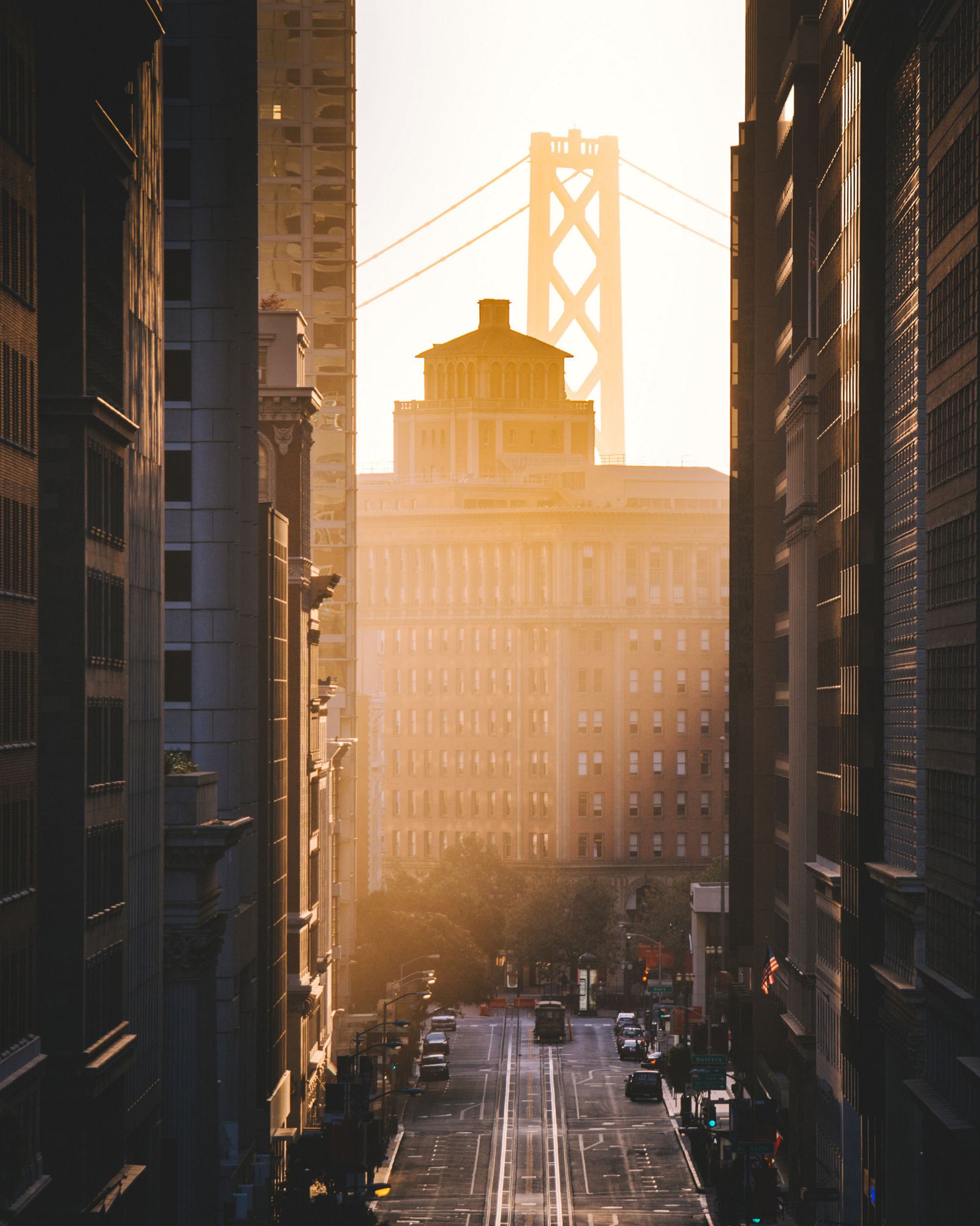 Downtown San Francisco with famous California Street illuminated in first golden morning light at sunrise in summer, San Francisco, California, USA, Downtown San Francisco with famous California Street illuminated
