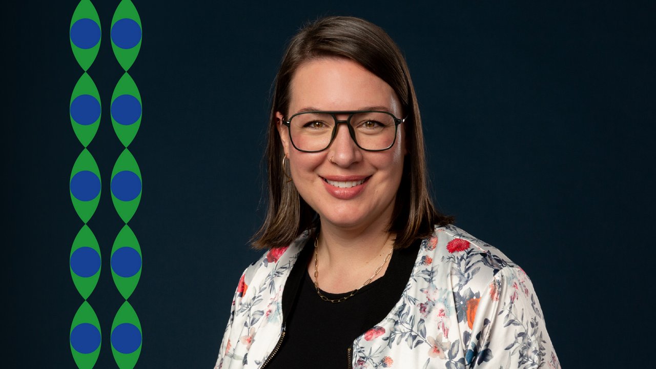 Jasmine Presson, Chief Strategy Officer at Mediaplus North America. Portrait of a smiling woman with glasses and shoulder-length brown hair, standing against a dark blue background. She wears a floral jacket over a black top. On the left side, green and blue graphic patterns run vertically.