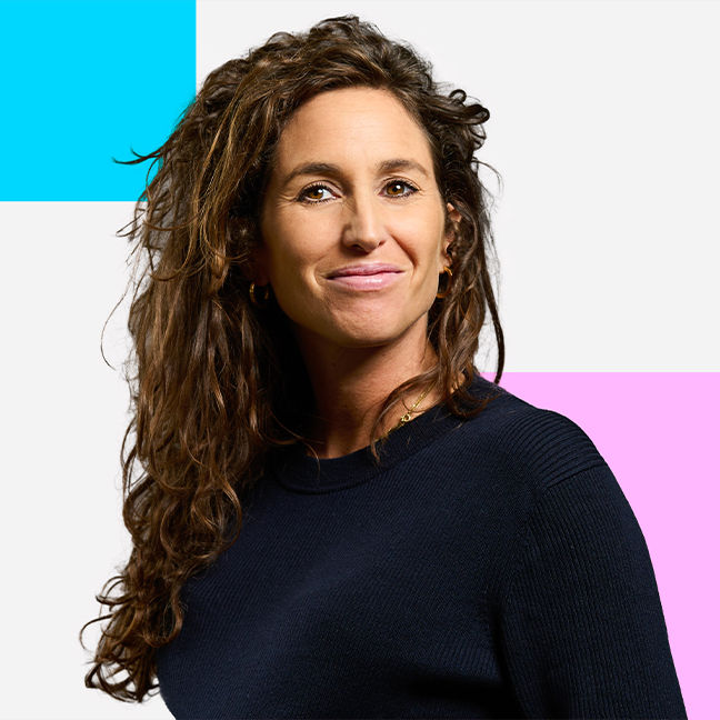 Julia Zimmermann, Managing Partner at Future Marketing: The picture shows a smiling woman with dark brown hair in a blazer and white blouse against a dark blue background.