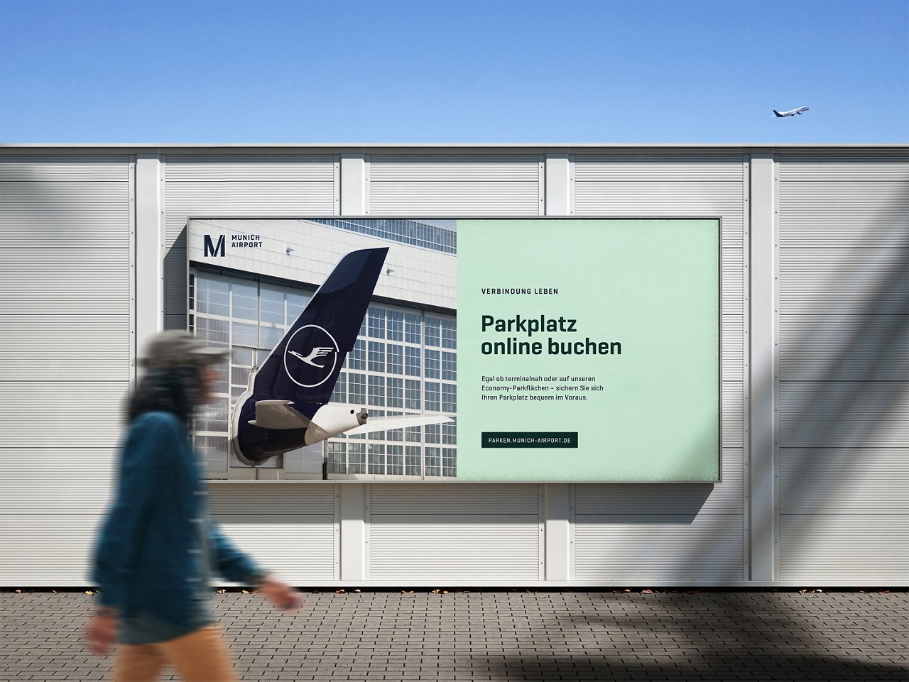 men walking past munich airport billboard