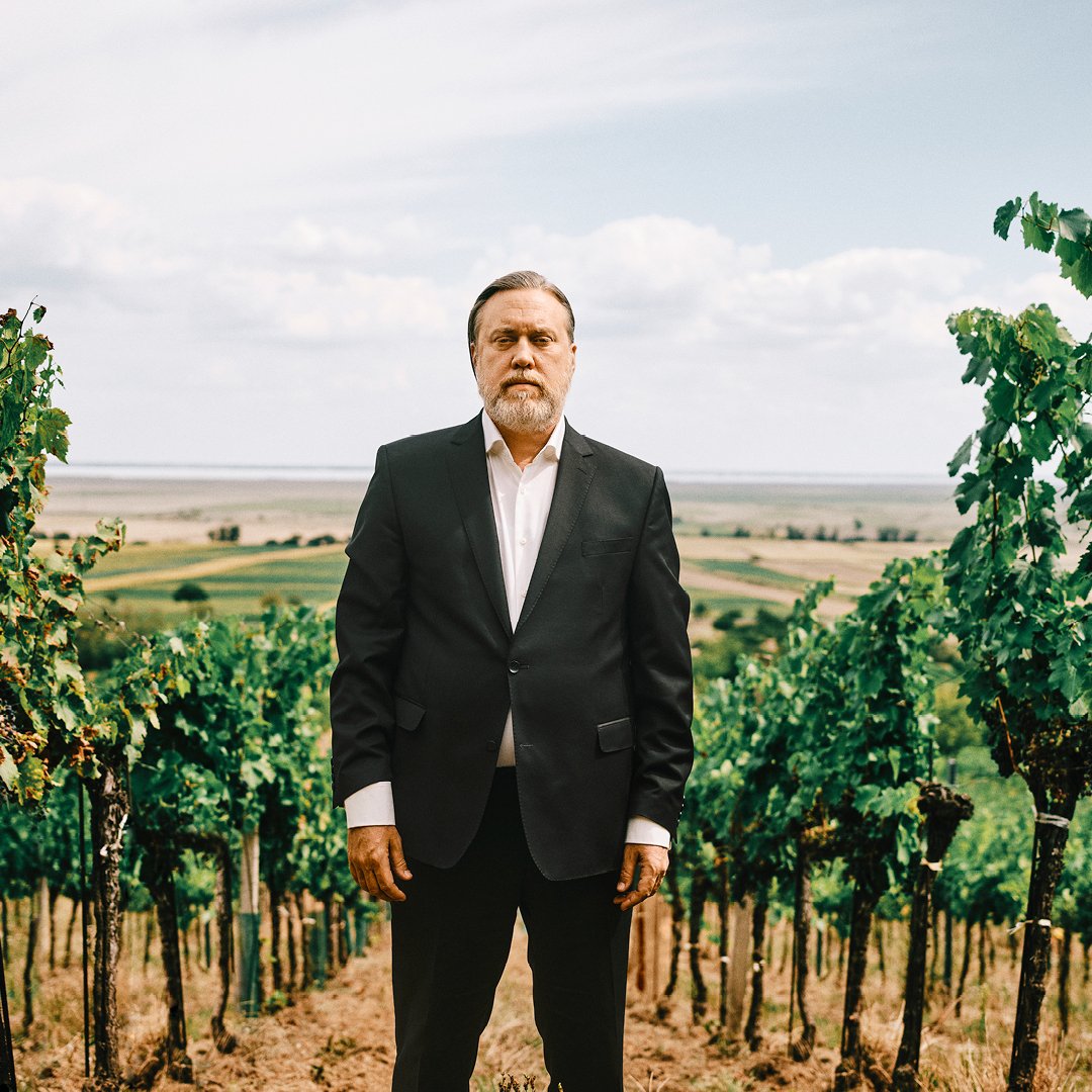 Character actor Nicholas Ofczarek stands in a winery