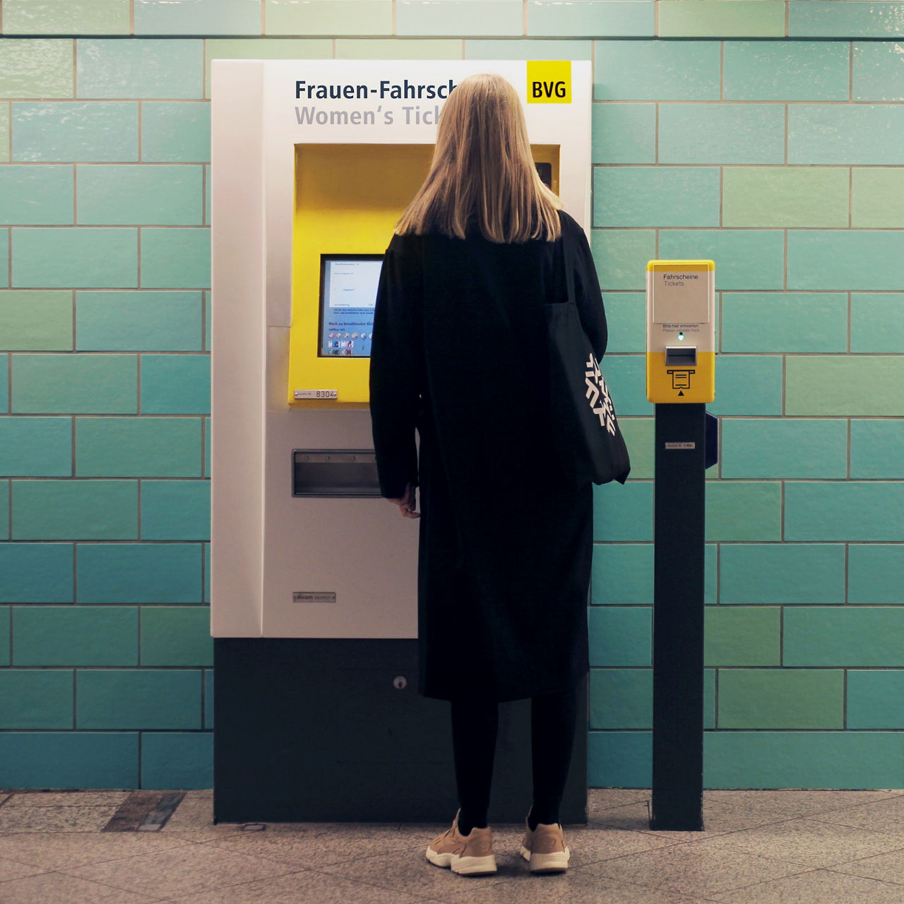 Woman buys ticket from BVG ticket machine for women's tickets