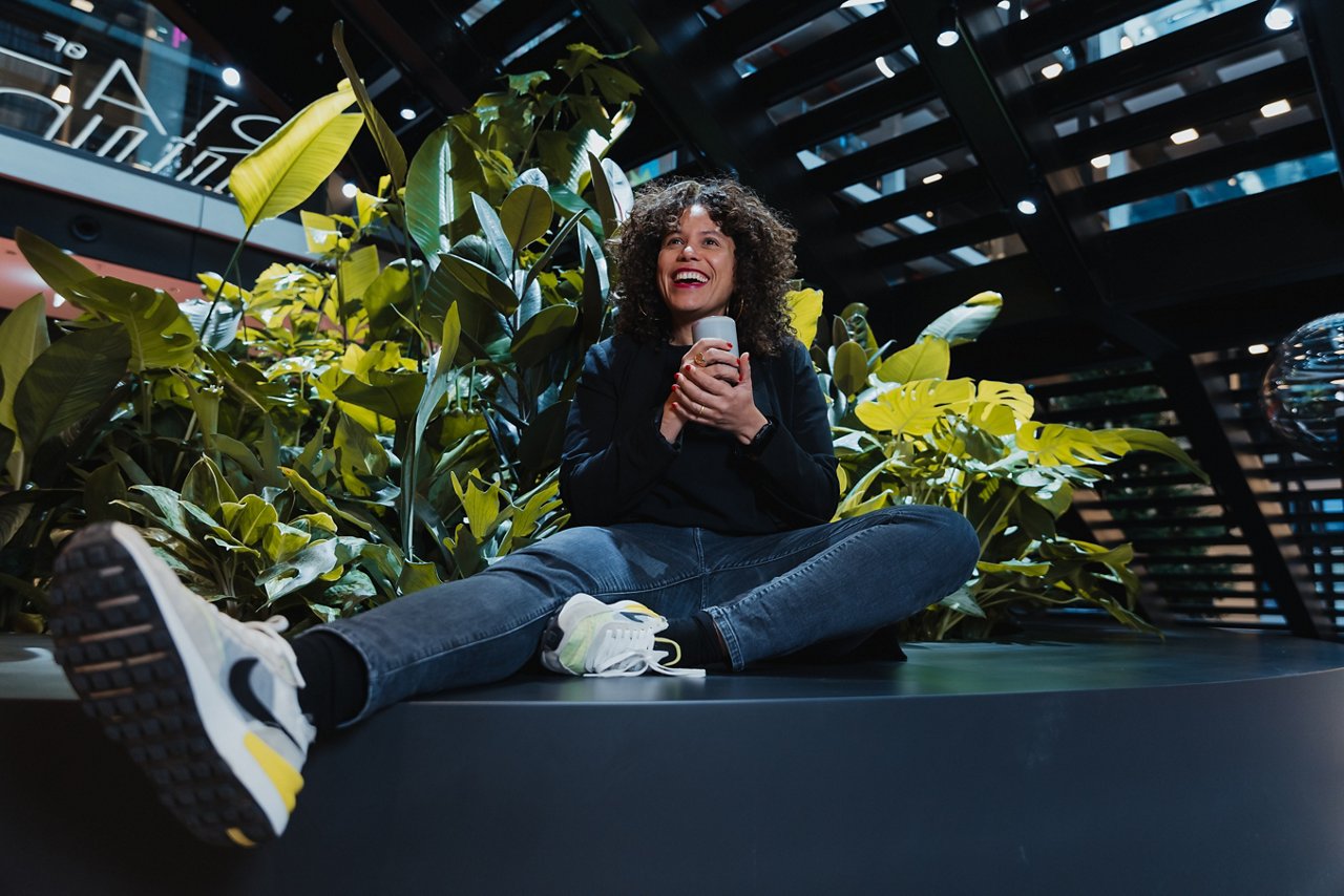 woman sitting in front of plants