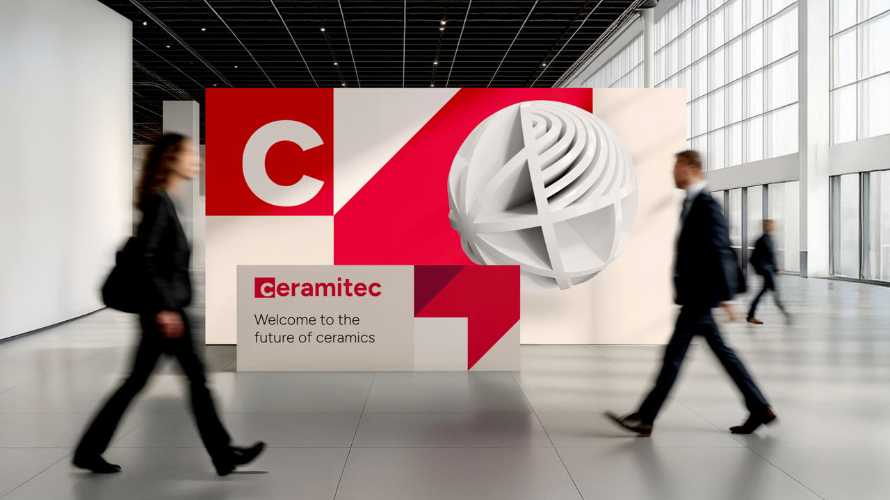 people walking past the ceramitec trade fair display