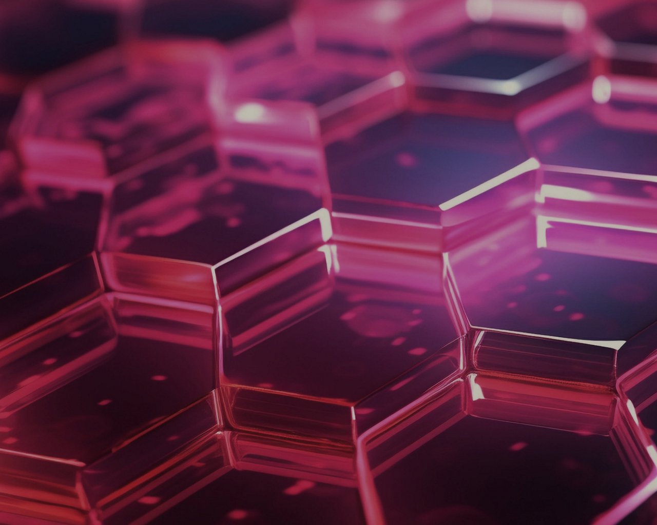 Close-up of transparent hexagonal shapes with a pink glow.