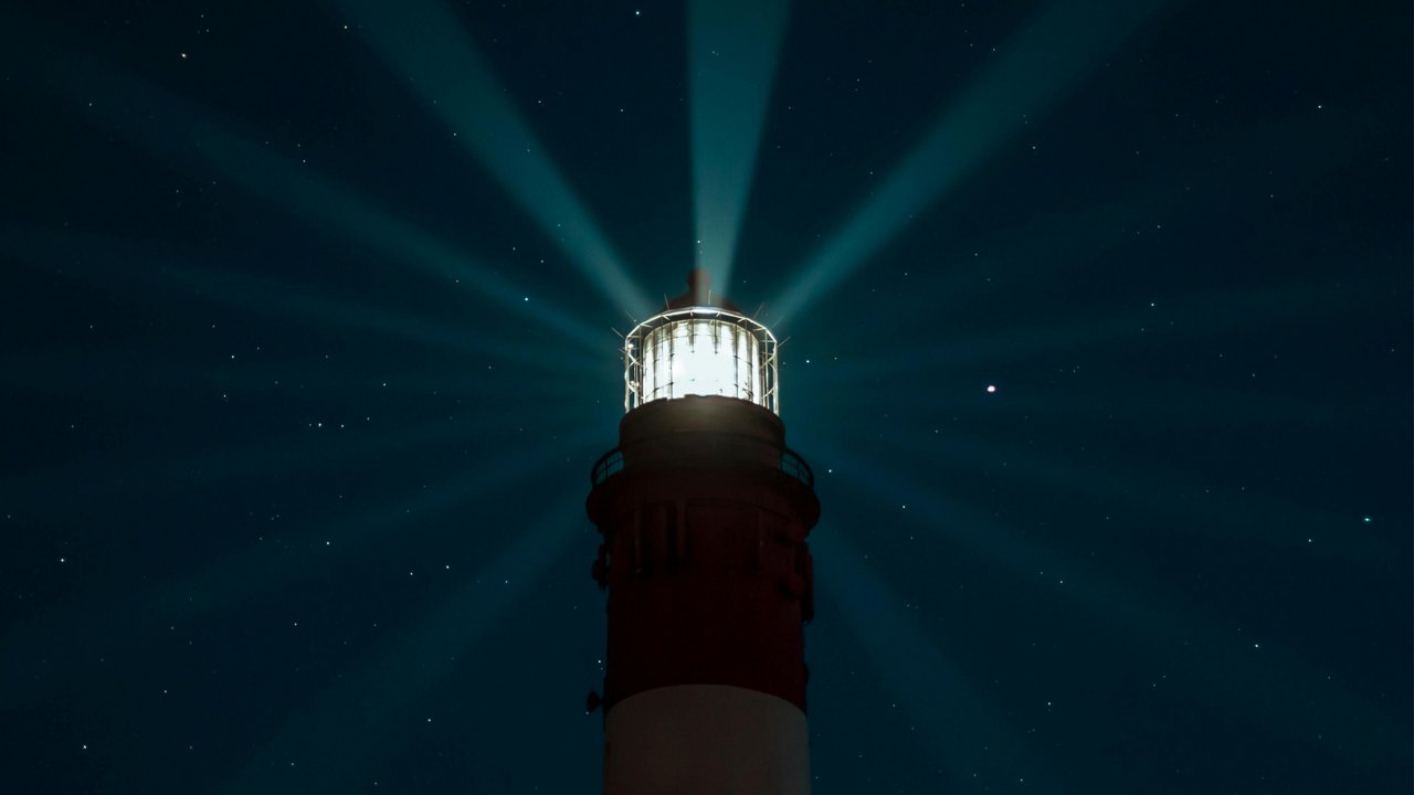Lighthouse in dark sky