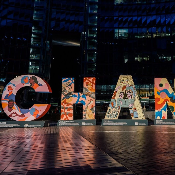 Artwork consisting of two-metre letters forming the word CHANGE at the Sony Center in Berlin at night