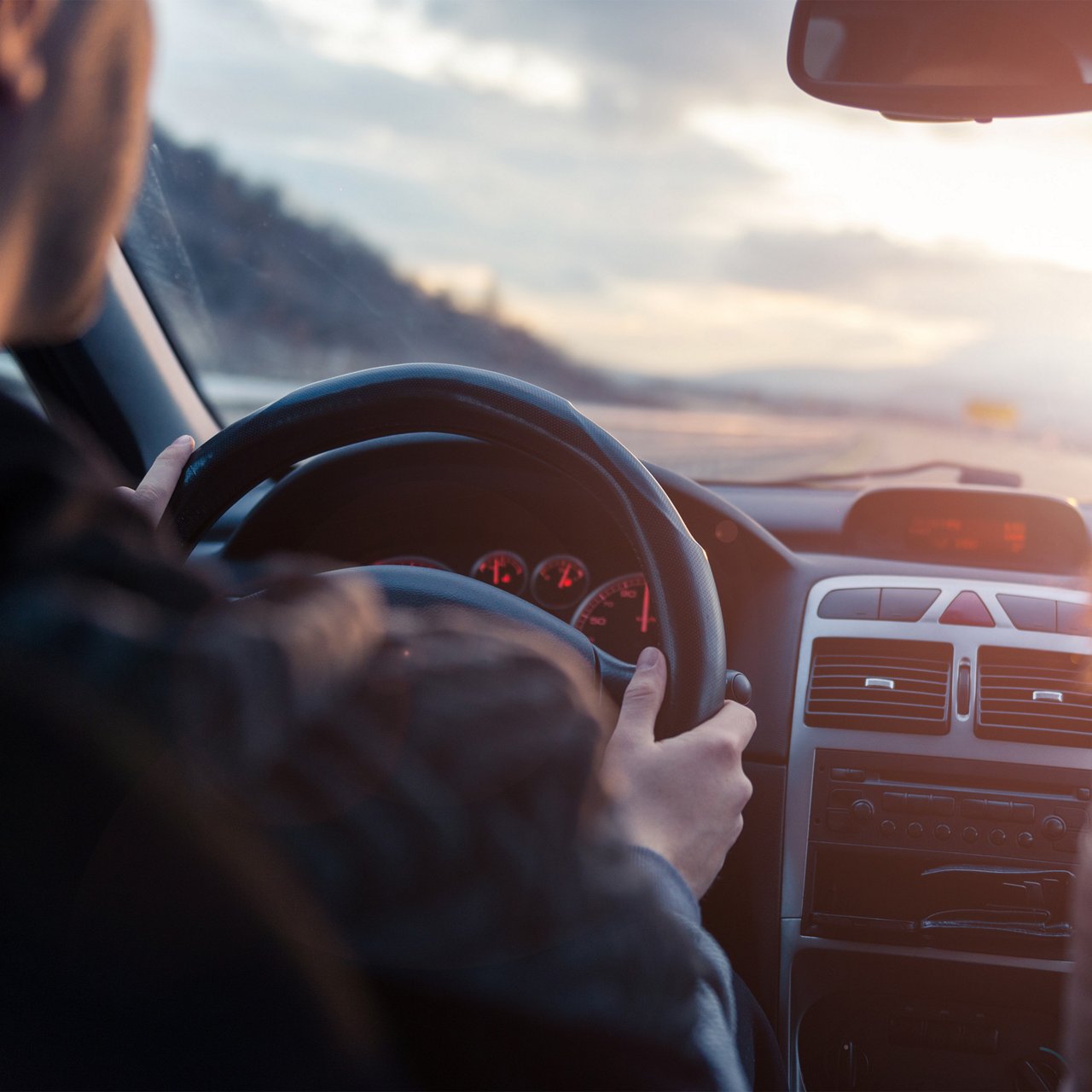Image from the backseat of a car showing the driver