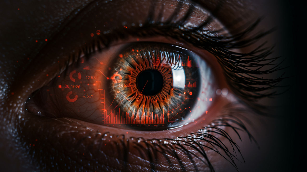 Close-up shot of an eye with data and graphs mirrored on the iris