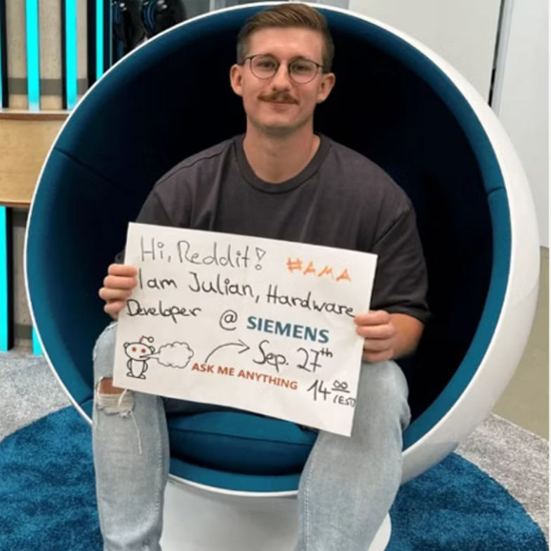 A man is holding a poster in his hands