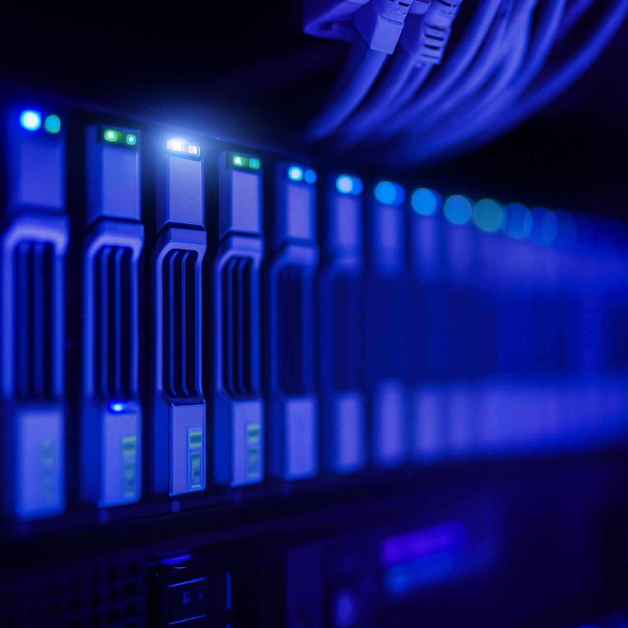 Close-up view of illuminated computer servers with blue lights and network cables