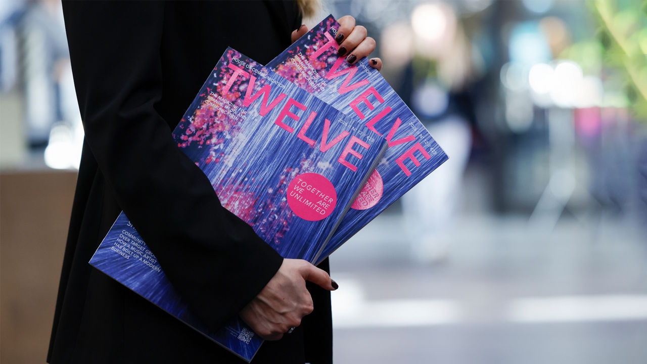 Two copies on twelve magazine in the hands of a person