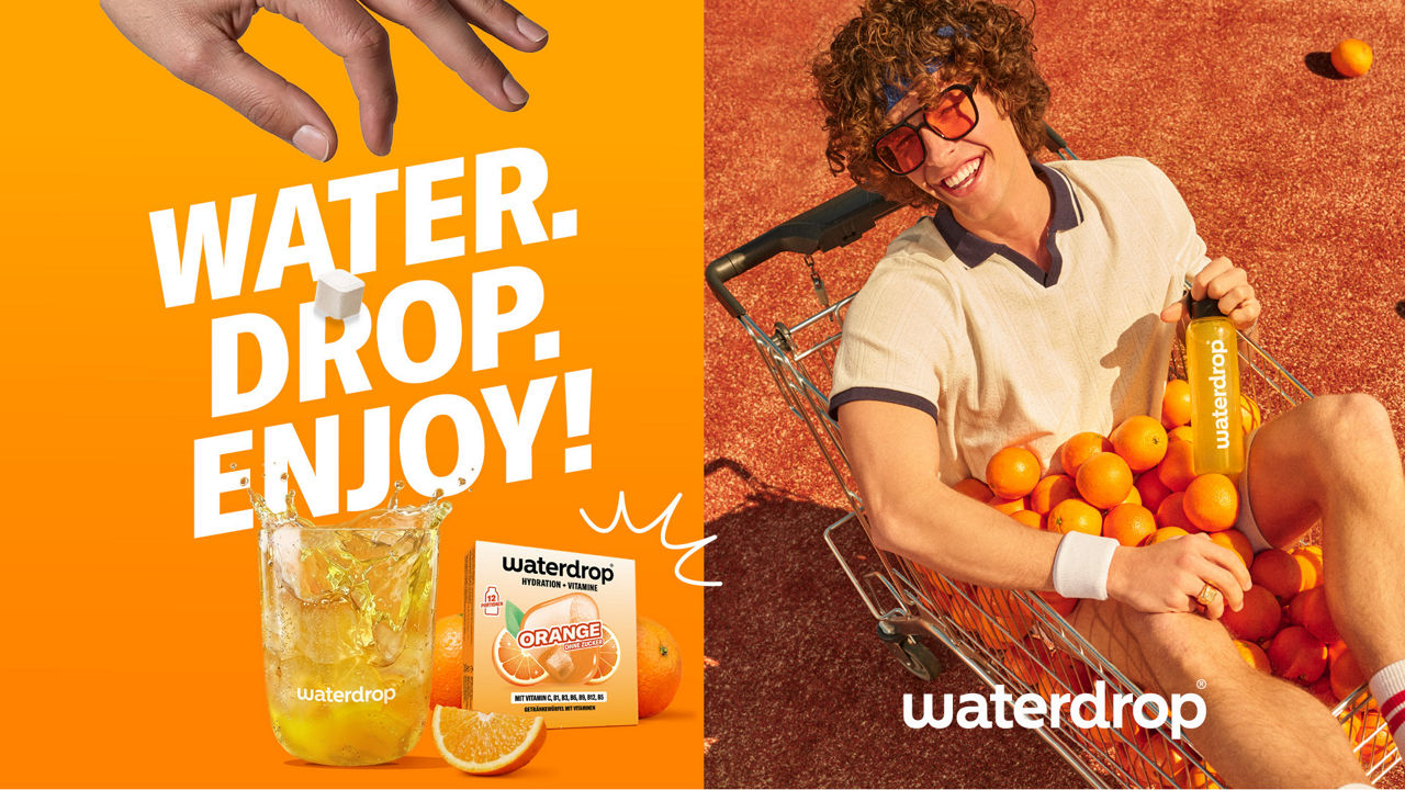 Advertisement by waterdrop featuring an orange color scheme: On the left, a glass of juice, product packaging, and the slogan “Water. Drop. Enjoy!”; on the right, a smiling person wearing sunglasses in a shopping cart full of oranges.