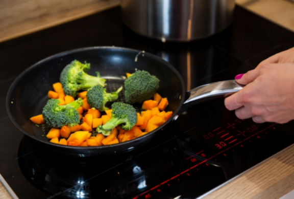 Man changing light bulb in pendant lamp indoors