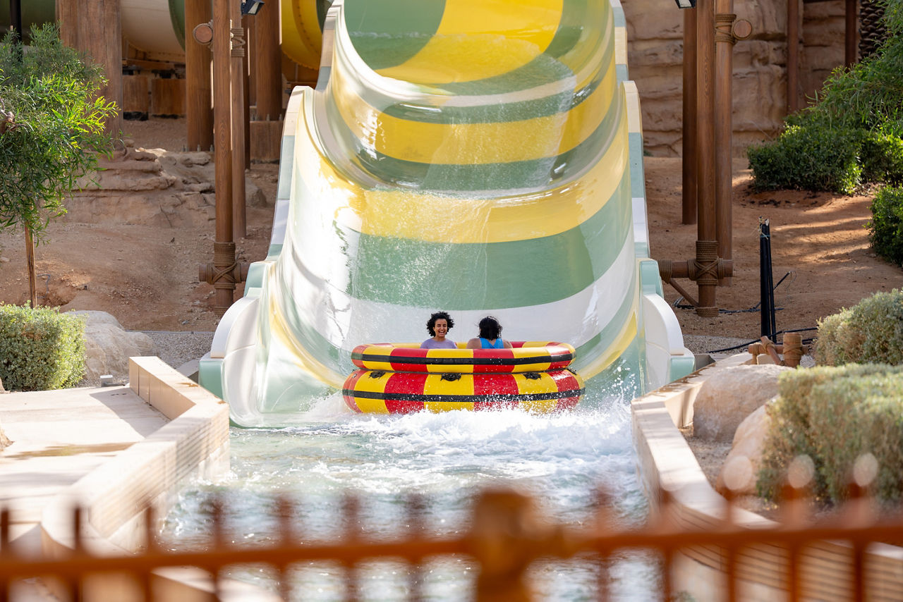 a family riding a raft slide at Aquarabia water park at Qiddiya City in Saudi Arabia
