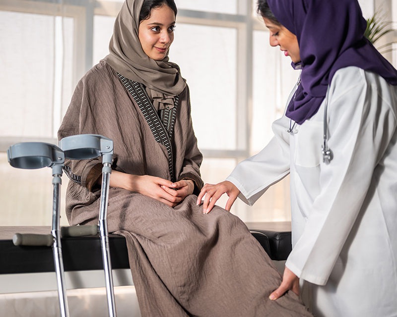 Healthcare professional assisting a patient during a medical consultation, representing Qiddiya City’s future healthcare facilities focused on health and wellbeing