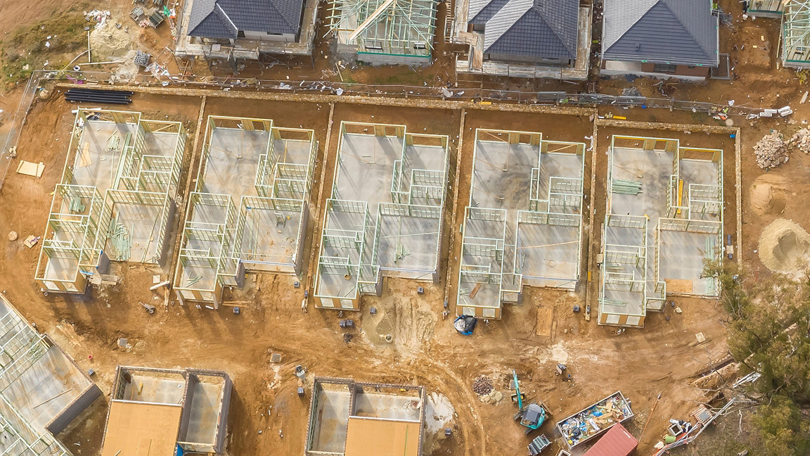 Aerial view of construction site, houses under construction