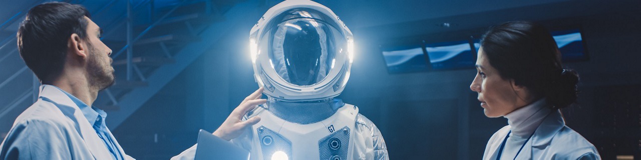 Diverse Team of Aerospace Engineers Design New Space Suit Adapted for Galaxy Exploration and Travel. Group of Scientists Wearing White Coats have Discussion, Use Computers. Constructing Astronaut Suit