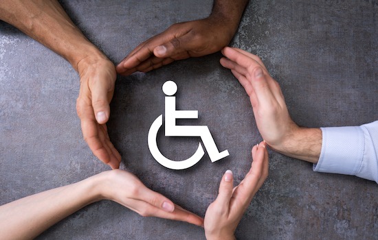 Close-up Of A Hands Protecting Disabled Handicap Icon