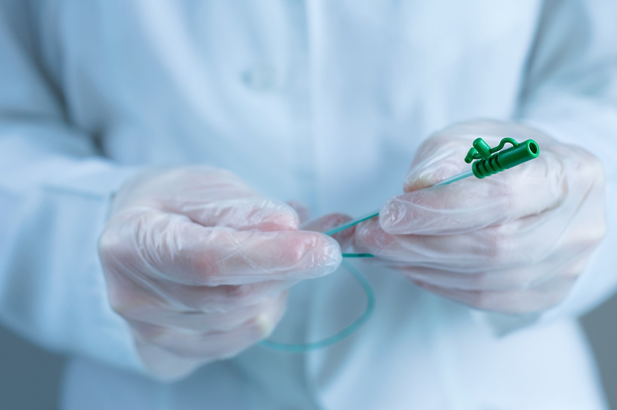 Urological catheter in the hands of a doctor. Close-up.