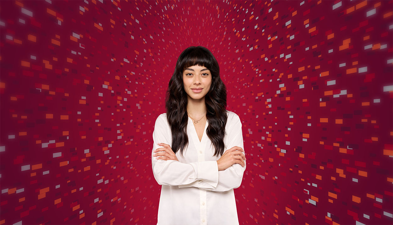 Woman with folded arms against red background