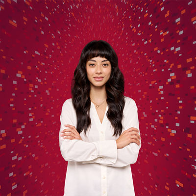 woman with folded arms on red background