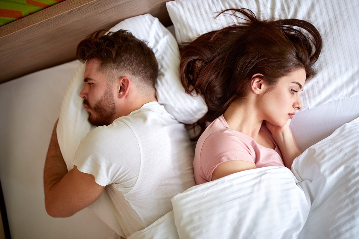 Couple with problems in relationship in bed